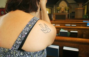 woman dove tat in pew - medium